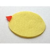 A whimsical yellow felt chick with an oval body and a tiny red triangle for a beak, looking ready to join the springtime fun at a Disney World Easter celebration.