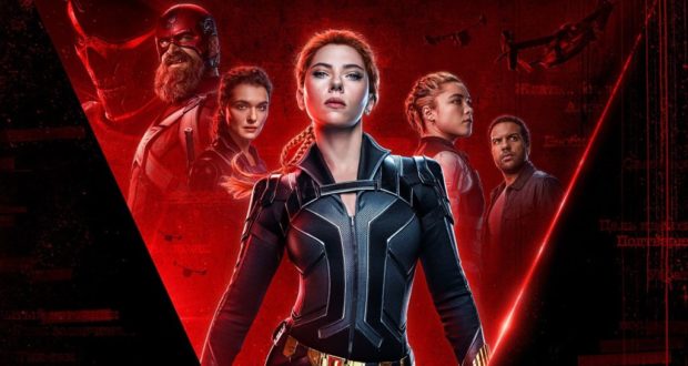 Marvel superheroes in iconic black and red suits strike powerful poses with fierce expressions against a dramatic red backdrop, echoing the high-energy atmosphere of an Avengers attraction. Their bold presence builds excitement for fans awaiting the upcoming May 7th release.