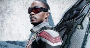 The Falcon wearing his new superhero suit with red goggles and mechanical wings poses in front of a gray backdrop, ready for action as seen in The Falcon and the Winter Soldier.