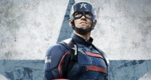 John Walker as Captain America poses heroically in front of a giant star mural on a rugged, weathered wall, creating a dynamic photo opportunity for Marvel fans.