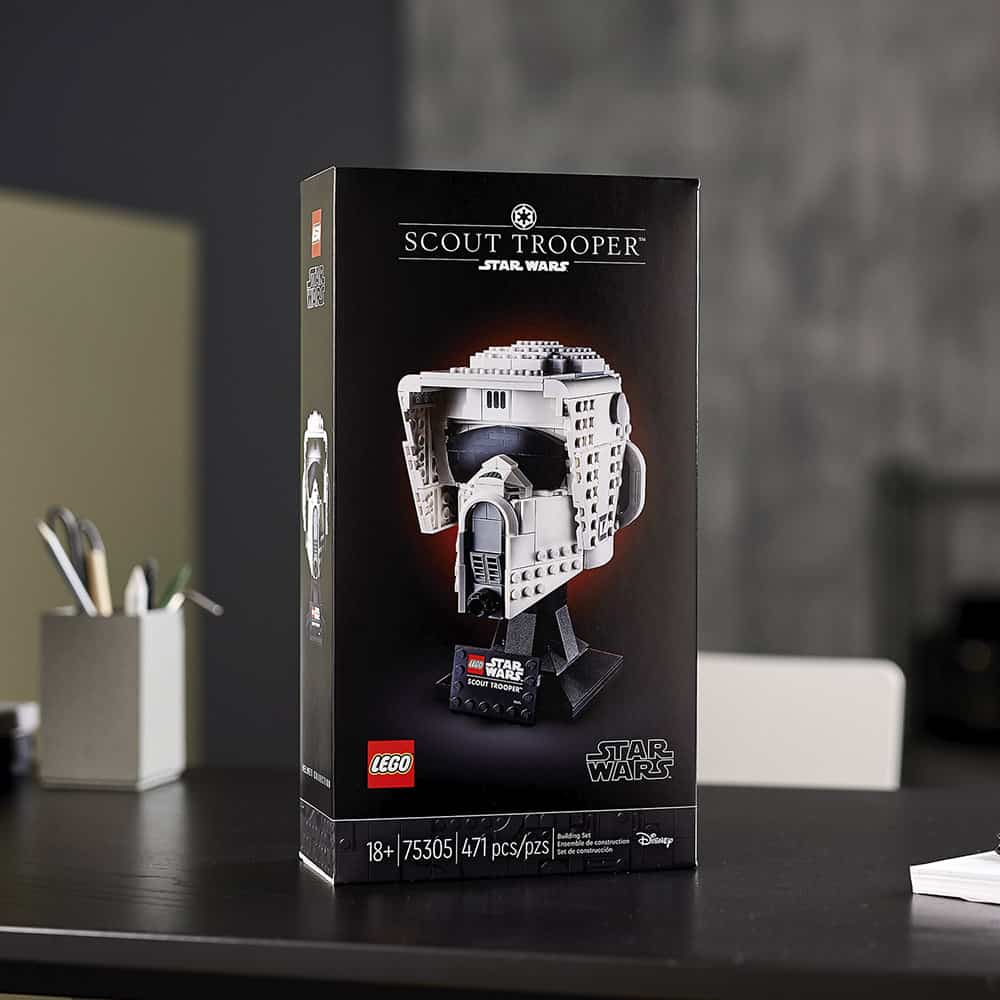 LEGO Star Wars Scout Trooper helmet box set displayed on a table, with an office background out of focus—ideal for Star Wars fans and theme park enthusiasts looking to bring the thrill of the galaxy home.