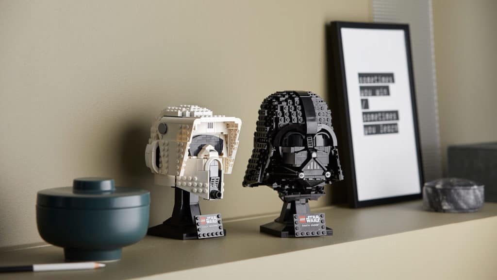 LEGO Star Wars helmets and collector sets line a beige display shelf, evoking the thrill of visiting Star Wars: Galaxy’s Edge, ready to transport fans into their own galactic adventure right at home.
