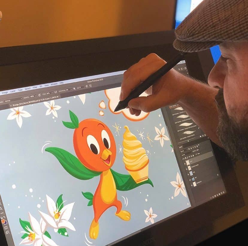 Orange Bird, the beloved Magic Kingdom character, is being brought to life in digital art as he happily holds an ice cream, with detailed mural plans coming together on a tablet and stylus—perfect inspiration for Disney fans looking forward to new park artwork.