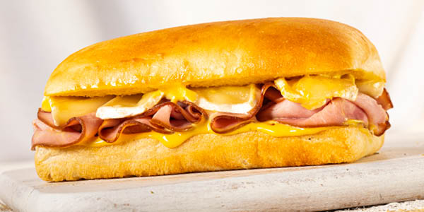 Le Frenchy," the mouthwatering toasted ham and melted cheese sandwich, served on a wooden board—an irresistible bite for foodies exploring Disney Springs.