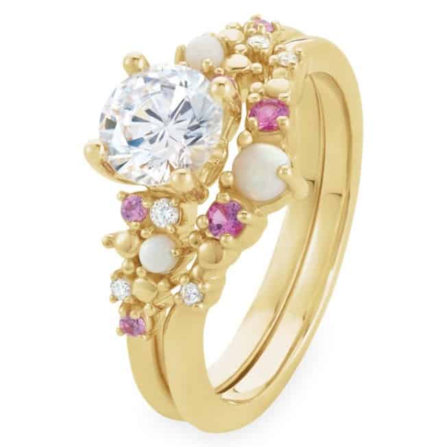 Step into the magic of Disney Parks with this dazzling gold engagement ring inspired by Disney's Fairy Tale Weddings. A stunning central diamond sparkles at the heart, accented by pink and white stones on a graceful gold band—capturing the elegance and romance found throughout Disney’s enchanting lands. Available exclusively at shopDisney, this ring is perfect for any fan dreaming of their own fairy tale moment.