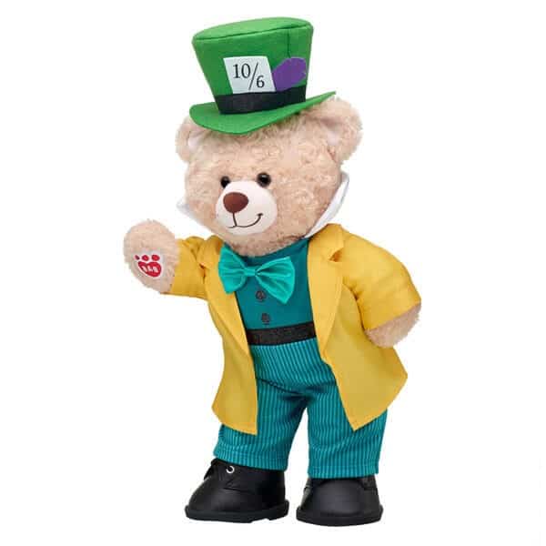 The Mad Hatter-inspired teddy bear from Build-A-Bear Workshop, sporting a bright yellow coat, teal bow tie, and iconic green top hat with “10/6,” channels the whimsical spirit of Disney’s Alice In Wonderland—perfect for fans seeking their own theme park adventure companion.