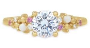 Enchanted Disney Fairy Tale Weddings engagement ring featuring a gleaming gold band crowned with a dazzling central diamond, surrounded by pink and white stones and sparkling accent diamonds, reminiscent of the magical romance found throughout Disney Parks—shop this fairy tale treasure at shopDisney.