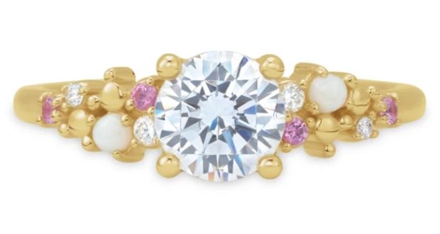 Enchanted Disney Fairy Tale Weddings engagement ring featuring a gleaming gold band crowned with a dazzling central diamond, surrounded by pink and white stones and sparkling accent diamonds, reminiscent of the magical romance found throughout Disney Parks—shop this fairy tale treasure at shopDisney.