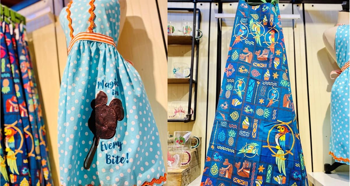 Two vibrant Disney aprons are featured, one in classic blue polka dots and the other adorned with tropical prints and parrots—must-have merchandise for fans looking to bring a bit of Disney magic home from Disney Springs or to celebrate their favorite parks in their own kitchen.