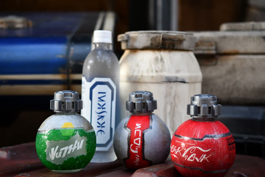 Four Star Wars-themed drink bottles—Coca-Cola, Sprite, and Dasani—sit on a table at Disney Parks, debuting as part of an exclusive Disney and Star Wars collaboration for fans visiting the galaxy’s edge.