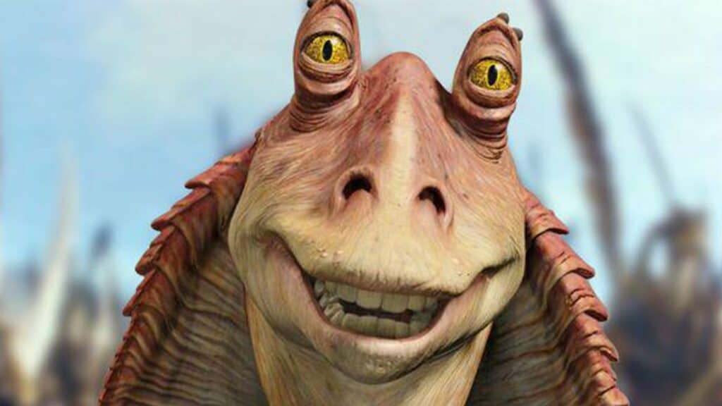 A close-up of Jar Jar Binks, the animated Star Wars alien with big yellow eyes and pinkish skin, smiling warmly as he greets guests at a Star Wars-themed attraction.