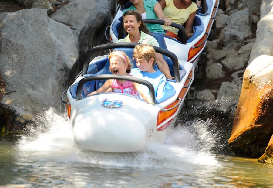 Thrill-seekers of all ages experience pure joy as they splash through the Matterhorn Bobsleds at Disneyland, grinning with excitement on a wild coaster adventure reminiscent of classic Disney magic.
