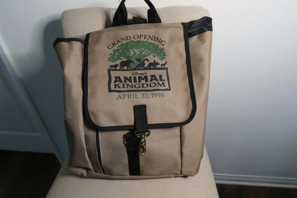 Tan backpack featuring the “Disney’s Animal Kingdom Grand Opening April 22, 1998” logo on the front flap—a nostalgic piece of Walt Disney World history and a coveted collectible for park fans and Disney memorabilia enthusiasts.