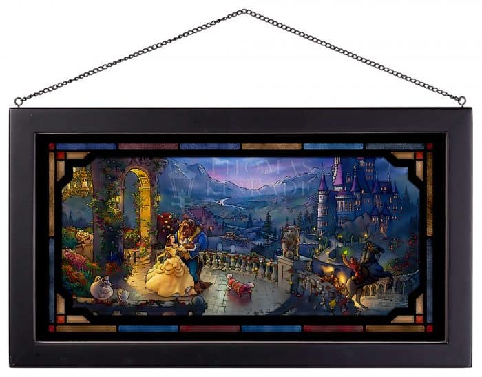 Framed stained glass artwork featuring Beauty and the Beast dancing in front of their enchanted castle, surrounded by familiar friends from the movie, reminiscent of magical Disney Park displays and created in a style inspired by Thomas Kinkade Studios.
