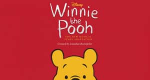 Winnie the Pooh’s iconic head stands out against a vibrant red background, accompanied by an announcement about the launch of a new musical stage adaptation for fans of beloved Disney entertainment.