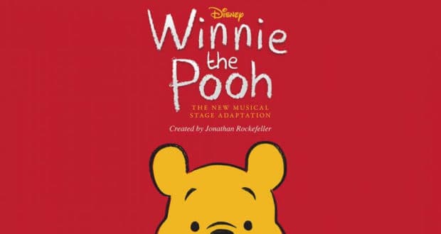 Winnie the Pooh’s iconic head stands out against a vibrant red background, accompanied by an announcement about the launch of a new musical stage adaptation for fans of beloved Disney entertainment.