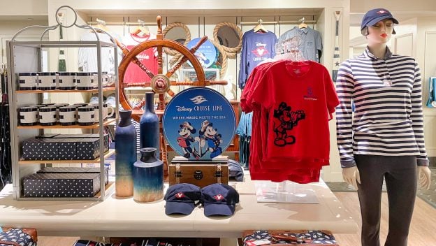 Disney Cruise Line merchandise on display at Disney’s Yacht Club Resort, showcasing colorful shirts, hats, and nautical-themed décor. The setup invites Disney fans to shop exclusive cruise-inspired souvenirs and capture the adventurous spirit of a high seas vacation—right in the heart of Walt Disney World Resort.