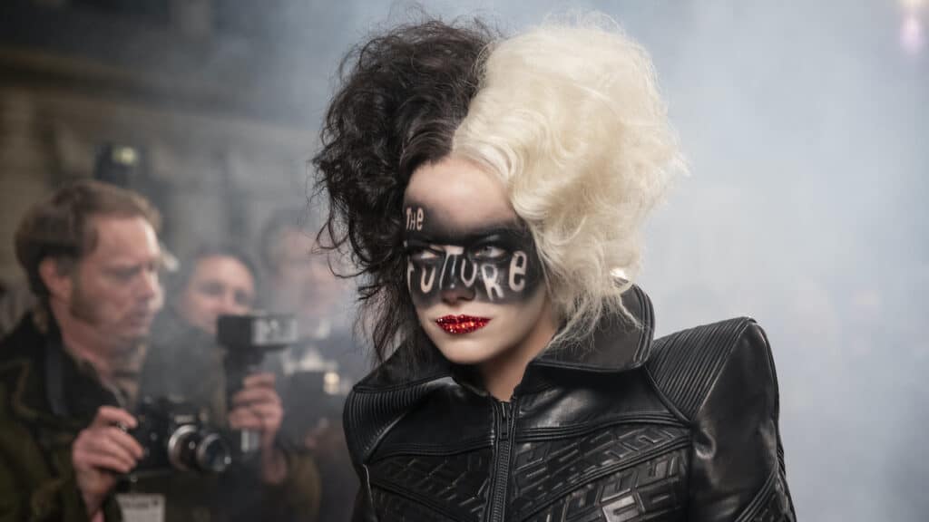 Cruella in her signature half-black, half-white hair, striking face paint reading "The Future," and a fierce black leather jacket—showcasing her iconic rebellious attitude as revealed in the latest Disney movie trailer.