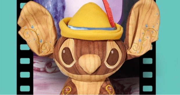 Stitch plush inspired by Pinocchio, featuring oversized ears, a playful wood-grain body, yellow hat, and filmstrip border set against a teal backdrop—ideal for Disney Parks collectors or fans of the Stitch Crashes Disney series.