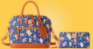 Blue Dooney & Bourke bag and wallet adorned with classic Disney Afternoon characters, complete with brown handles, showcased on a bright yellow backdrop—the ultimate accessories for your next adventure at Disney Springs.