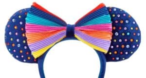 Step into the magic with navy blue Minnie Mouse ears featuring sparkling rainbow gems and a vibrant rainbow-striped bow, inspired by shopDisney’s Striped Ear Headband collection—perfect for showing your Disney pride on Main Street, U.S.A.