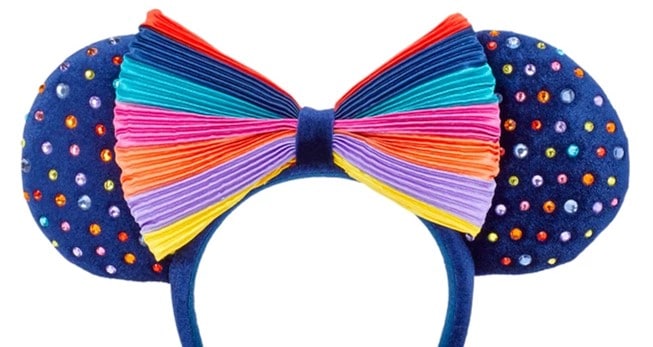Step into the magic with navy blue Minnie Mouse ears featuring sparkling rainbow gems and a vibrant rainbow-striped bow, inspired by shopDisney’s Striped Ear Headband collection—perfect for showing your Disney pride on Main Street, U.S.A.