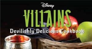 Unleash your villainous side with the Disney Villains Devilishly Delicious Cookbook, just like you’d find at Disney parks. Tempting apples and a gleaming silver cup await on a rustic wooden table, reminiscent of treats served during Oogie Boogie Bash or Mickey’s Not-So-Scary Halloween Party. Experience recipes inspired by your favorite Disney Villains—perfect for fans who enjoy adding a magical hint of mischief to their kitchen adventures, straight from the world of Disney entertainment.