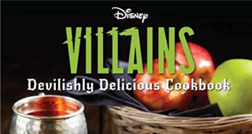 Unleash your villainous side with the Disney Villains Devilishly Delicious Cookbook, just like you’d find at Disney parks. Tempting apples and a gleaming silver cup await on a rustic wooden table, reminiscent of treats served during Oogie Boogie Bash or Mickey’s Not-So-Scary Halloween Party. Experience recipes inspired by your favorite Disney Villains—perfect for fans who enjoy adding a magical hint of mischief to their kitchen adventures, straight from the world of Disney entertainment.