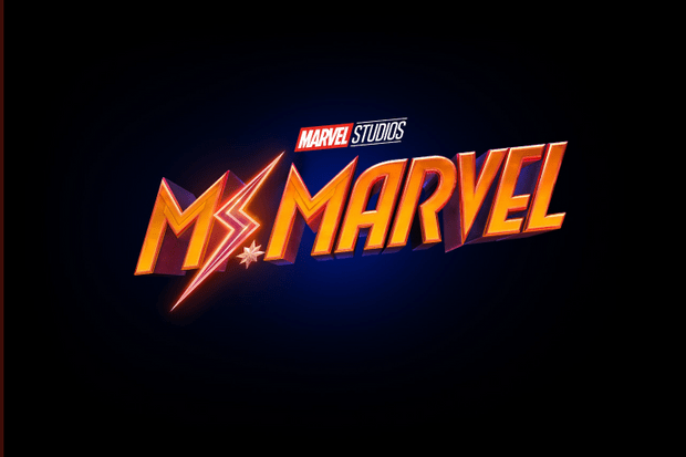 Ms. Marvel’s vibrant orange-yellow logo, electrified with a lightning bolt and topped by the Marvel Studios emblem, captures the high-energy excitement you’d expect to see lighting up an entrance at Avengers Campus.