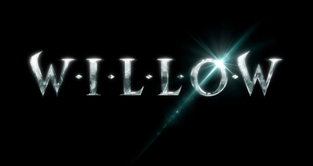 The word "WILLOW" gleams in metallic letters against a dramatic black backdrop, with a magical flare shining from the "O"—bringing the fantasy and adventure of Disney+’s Willow universe to life for fans immersed in the enchantment of Disney entertainment.