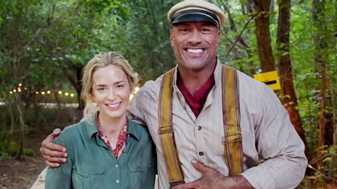 Guests share a joyful moment beneath lush greenery and golden sunlight, embodying the excitement of Disney’s Jungle Cruise adventure.