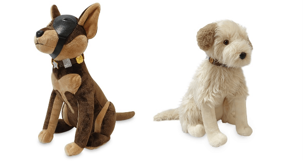 Wink and Buddy Plushes—beloved Pals from Universal Studios, one sporting a soft brown coat with a signature black mask and the other fluffy white—sit together against a crisp white backdrop, all set to charm guests with their signature theme park outfits.