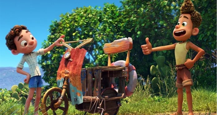 Two animated boys, reminiscent of Pixar’s Luca, beam with joy next to a homemade bike under a bright blue sky in an enchanting, family-friendly setting filled with lush trees and greenery—capturing the magic and adventurous spirit of a themed entertainment experience.
