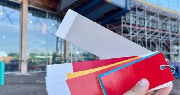 Colorful paint swatches are fanned out against the backdrop of EPCOT’s Creations Shop under construction, with scaffolding hinting at the ongoing transformation and creative energy that Disney Imagineers bring to making theme park magic.