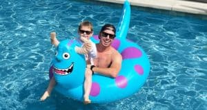 Guests rocking sunglasses enjoy poolside fun on a vibrant blue Sulley Float, grinning for the camera as their Monsters, Inc.-themed ride brings extra excitement to this sun-soaked adventure.