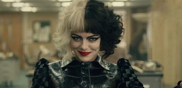 Cruella strikes a confident pose indoors, her iconic half-black, half-white hair and bold makeup complemented by a sleek black leather outfit—capturing the edgy style that continues to inspire fans at Disney Parks.