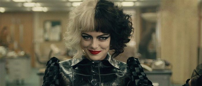 Cruella strikes a confident pose indoors, her iconic half-black, half-white hair and bold makeup complemented by a sleek black leather outfit—capturing the edgy style that continues to inspire fans at Disney Parks.