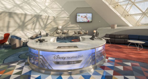 Disney Vacation Club Member Lounge featuring sleek, modern seating, a flat-screen TV, and a vibrant geometric carpet illuminated by a skylight—a stylish retreat reserved exclusively for eligible Disney Vacation Club members seeking extra Disney perks during their theme park visit.