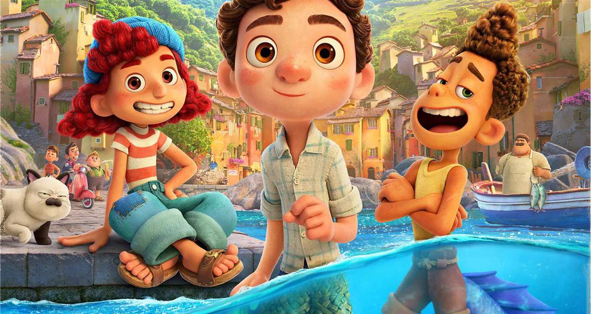 Luca, Alberto, and Giulia grin in front of the vibrant seaside village from Pixar’s Luca, with colorful houses and boats evoking the lively atmosphere of Portorosso at a Pixar-themed section of a theme park.