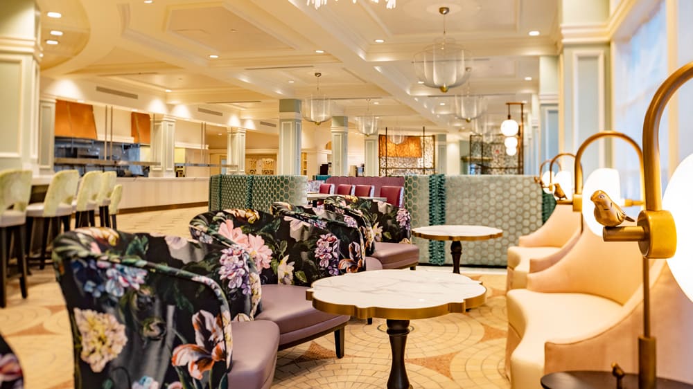 Grand Floridian-inspired lounge with elegant floral chairs, round tables, and warm lighting, capturing the upscale ambiance and classic Disney magic familiar to Walt Disney World fans.