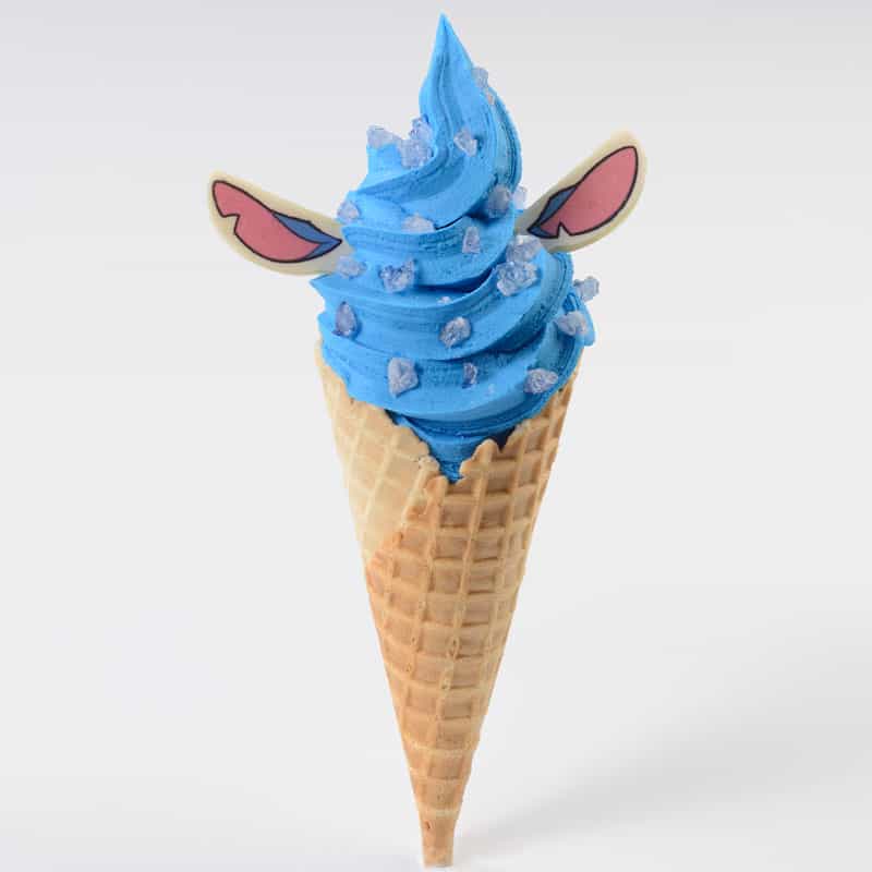 Stitch-inspired blue ice cream in a waffle cone, topped with candy ears and blue sprinkles to resemble the mischievous alien, available for a limited time at Disney’s Polynesian Village Resort.