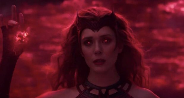 Scarlet Witch stands with glowing red eyes and a raised hand, enveloped in swirling scarlet energy against a dramatic dark backdrop—capturing the cinematic magic of the WandaVision finale, as if guests have stepped into an immersive Marvel experience.