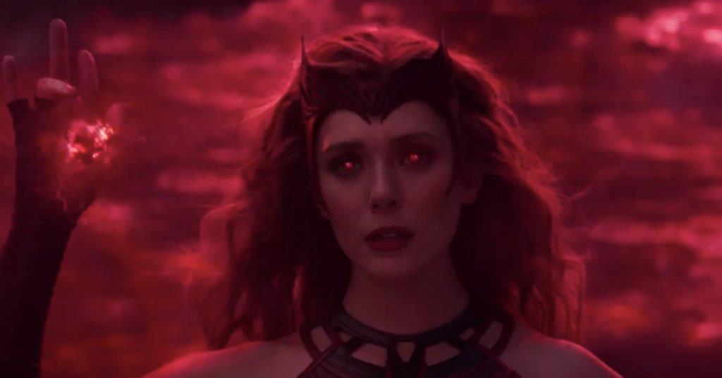 Scarlet Witch stands with glowing red eyes and a raised hand, enveloped in swirling scarlet energy against a dramatic dark backdrop—capturing the cinematic magic of the WandaVision finale, as if guests have stepped into an immersive Marvel experience.