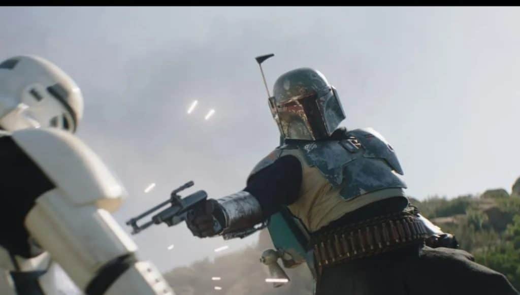 Boba Fett, in an action-packed moment from The Book of Boba Fett, fires his blaster at a stormtrooper amidst outdoor excitement, sparks lighting up the scene—capturing the cinematic thrills fans experience at Star Wars: Galaxy’s Edge.