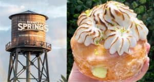 The iconic Disney Springs water tower rises in the background as a guest shows off the newest Key Lime Pie Donut, topped with perfectly toasted meringue, ready to delight visitors with its citrusy sweetness.