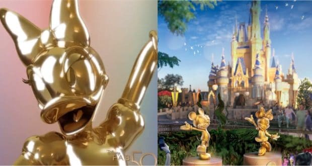 Minnie Mouse and Daisy Duck gold statues from the Disney Fab 50 collection gleam in front of Cinderella Castle at Walt Disney World, surrounded by lush trees beneath a bright blue sky.