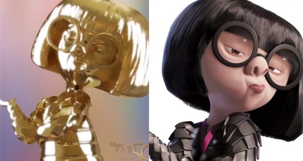 Edna Mode, in her iconic bob haircut and round glasses with sleek dark attire, poses alongside a gleaming gold statue as part of the Disney Fab 50 Character Collection at Walt Disney World.