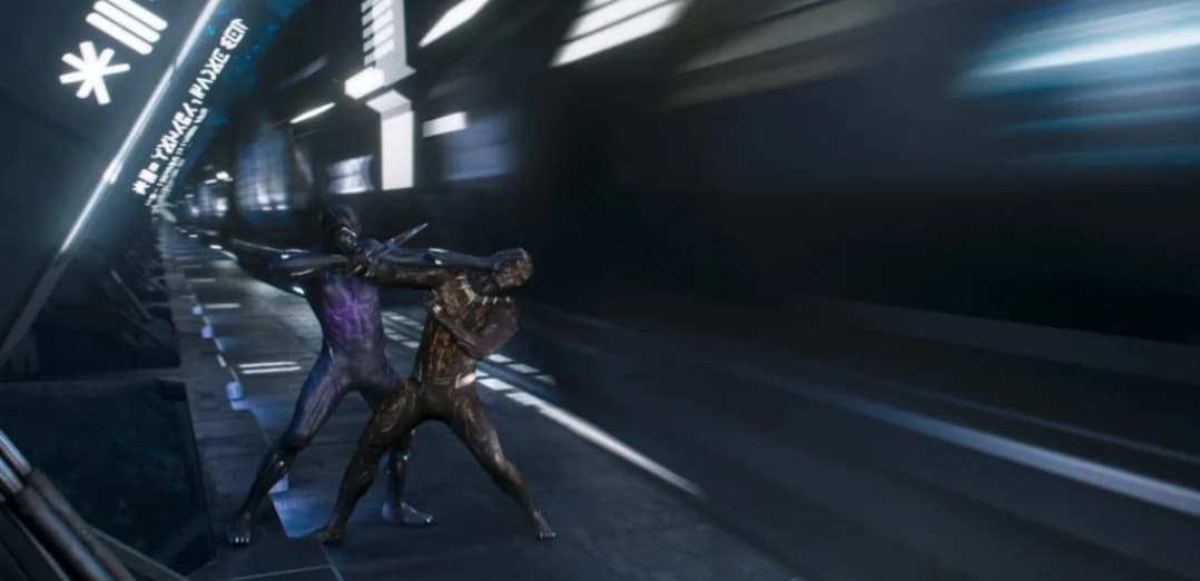 Guests witness two armored heroes battling at lightning speed inside a glowing, futuristic train tunnel, with vibrant lights streaking past—a heart-pounding spectacle reminiscent of scenes from Wakanda found in Black Panther attractions at Disney Parks.
