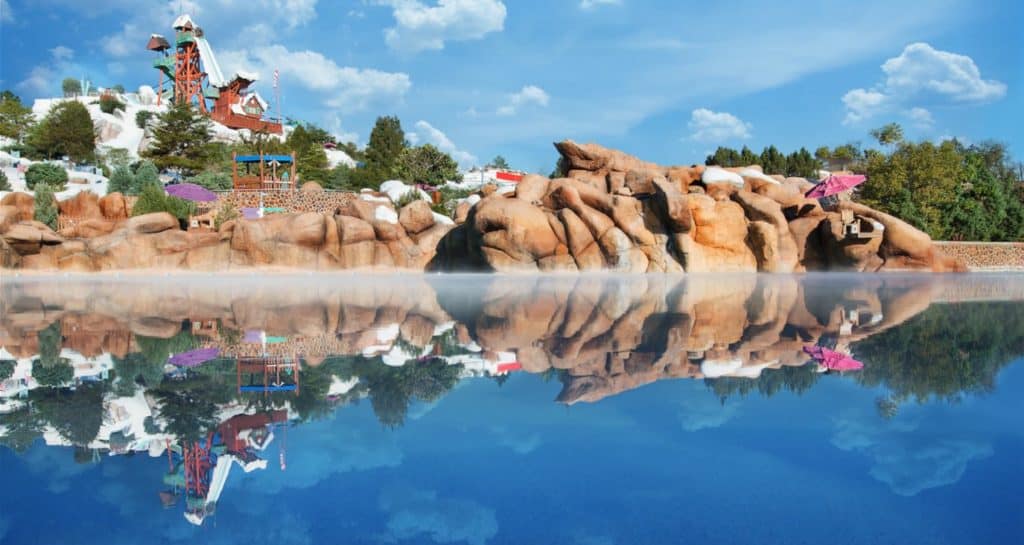 Blizzard Beach at Disney World features a rocky, snow-themed landscape with thrilling waterslides and crystal-clear blue water that perfectly reflects the winter wonderland vibe—an iconic spot where fans can enjoy frosty fun and splash-filled adventures in the heart of Disney’s water park magic.