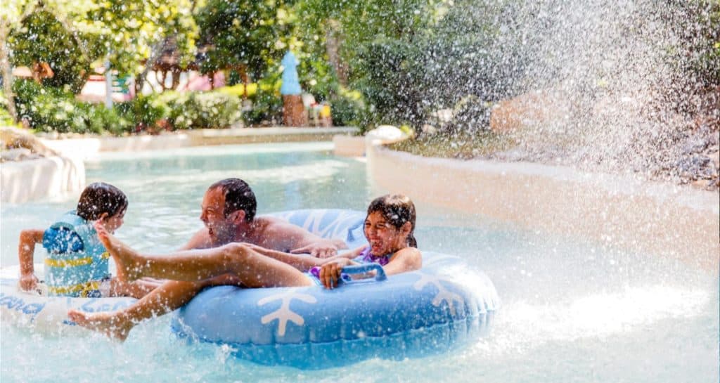 A family getting wet in a tube at Disney's Blizzard Beach Water Park.